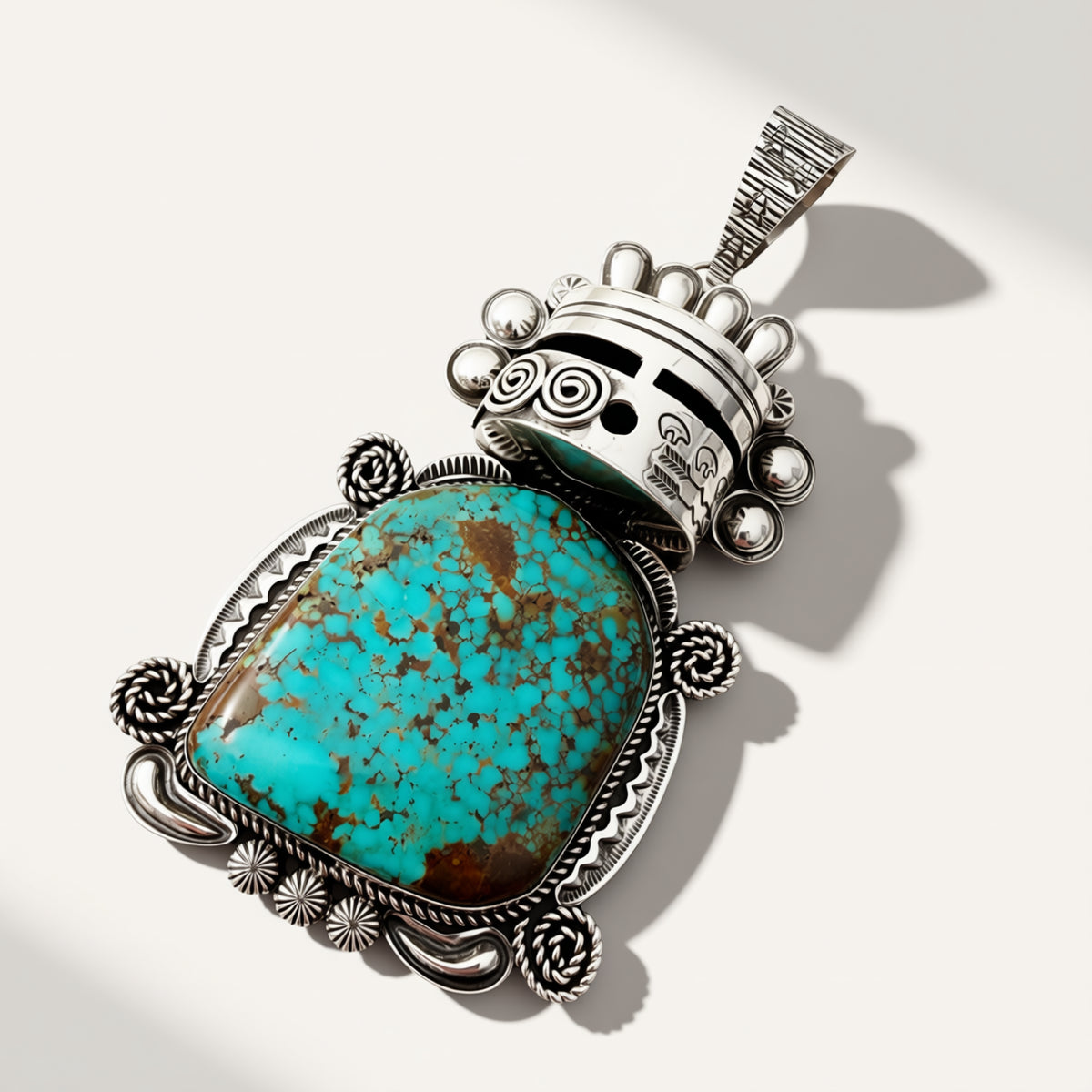silver warrior pendant with turquoise stone on a beige background