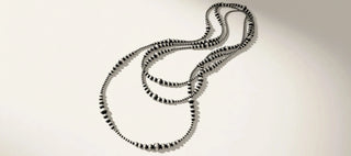 Silver necklace on a beige background