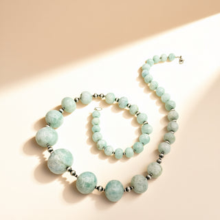 Necklace with blue beads and black pearls on a beige background