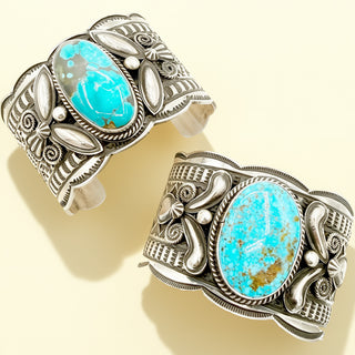 Two silver cuff bracelets with turquoise stones on a beige background