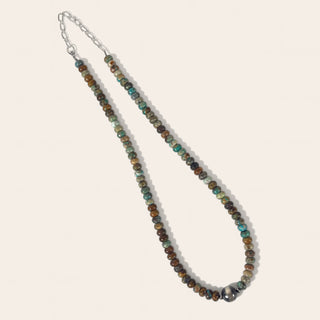 Beaded necklace with multicolored beads on a light background
