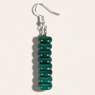 Green beaded earring on a white background
