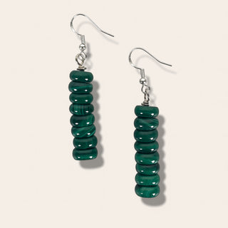 Pair of green beaded earrings on a white background