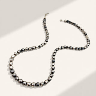 Black and silver beaded necklace on a white background
