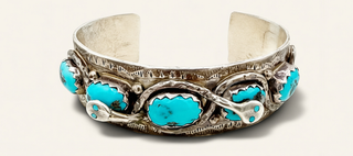Silver bracelet with turquoise stones on a white background