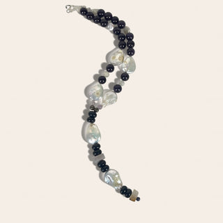 Necklace with black and white beads on a light background
