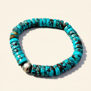 Blue beaded bracelet on a beige background