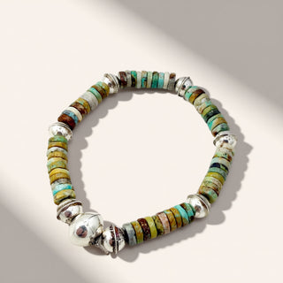 Multicolored beaded bracelet on a light gray background