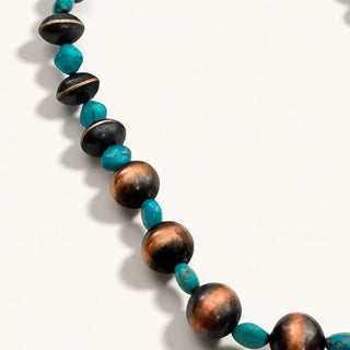 Necklace with brown and turquoise beads on a white background