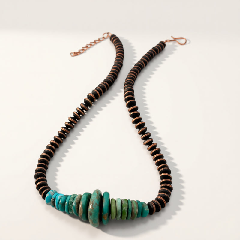 Necklace with brown and turquoise beads on a white background