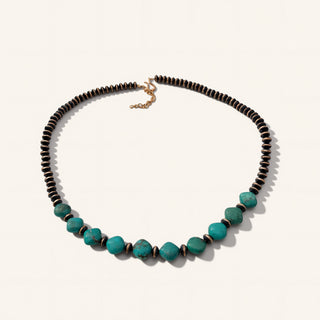 Necklace with black and turquoise beads on a white background