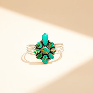 Silver ring with a turquoise stone on a beige background