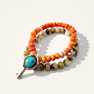 Beaded bracelet with a turquoise stone on a white background