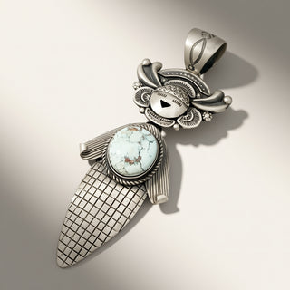 Silver pendant with turquoise stone on a neutral background