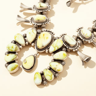 Necklace with yellow stone pendants on a beige background