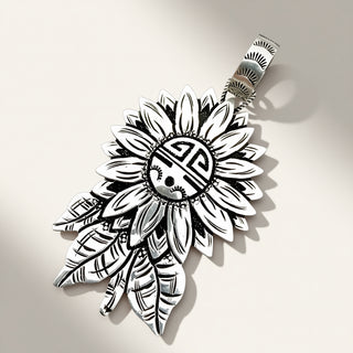 A silver-toned pendant shaped like a sunflower with engraved leaf details and a circular medallion in the center, shown on a plain light background.
