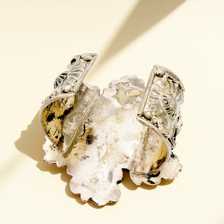 Decorative cuff  with leaf design on a beige background