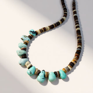 Necklace with turquoise and brown beads on a white background
