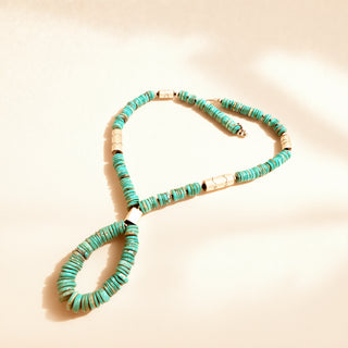 Turquoise stone necklace on a beige background