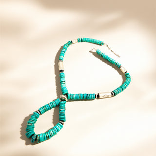 Turquoise stone necklace on a beige background