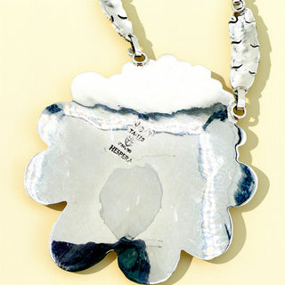 Silver necklace stamp on a beige background