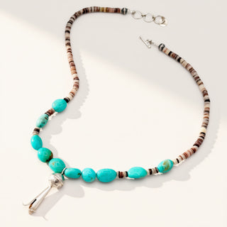 Beaded turquoise necklace on a beige background