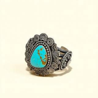 Decorative cuff with turquoise stone on a beige background