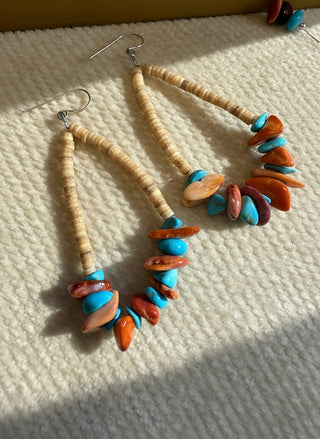 Earrings with multicolored beads on a textured surface