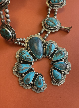 Turquoise stone jewelry set on an orange