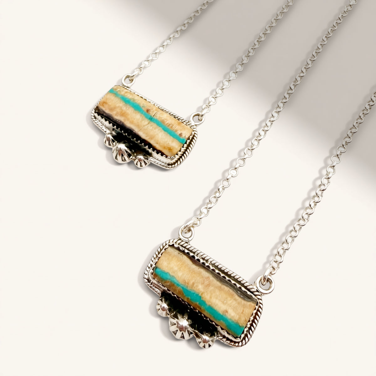 Necklace with a rectangular pendant featuring turquoise and black stripes on a white background