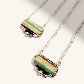 Necklace with a rectangular pendant featuring turquoise and black stripes on a white background