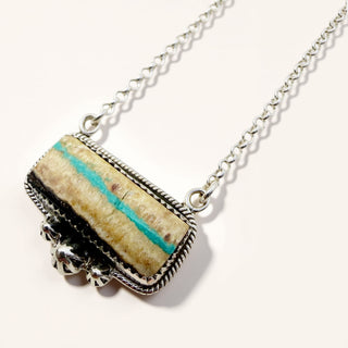 Necklace with a rectangular pendant featuring a turquoise stripe on a white background