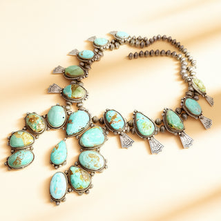 Turquoise stone necklace on a beige background
