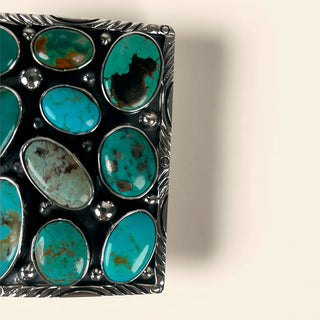 Silver jewelry box with turquoise stones on a beige background