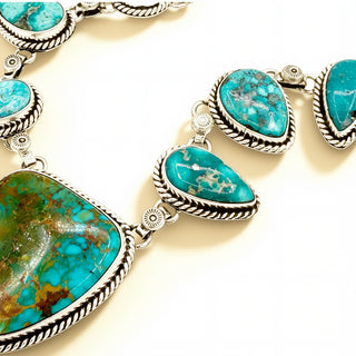 Turquoise stone necklace with silver accents on a light background