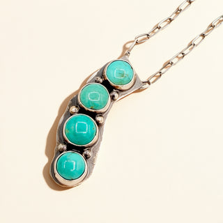Necklace with turquoise stones on a beige background