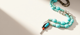 Turquoise beaded necklace with a decorative clasp on a light background