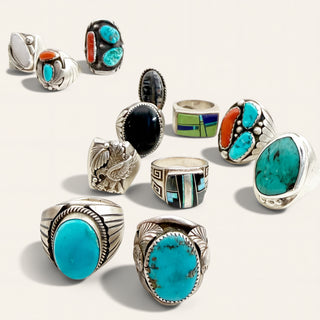 Several turquoise and multi-color rings on a beige background