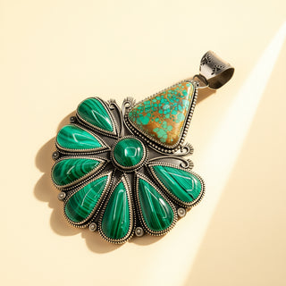 Turquoise pendant with silver setting on a beige background