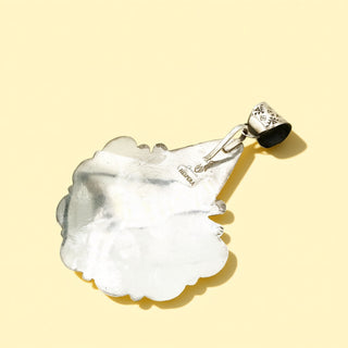 Silver pendant stamp  on a beige background