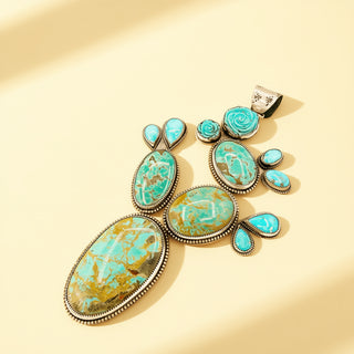 Turquoise stone pendant on a beige background
