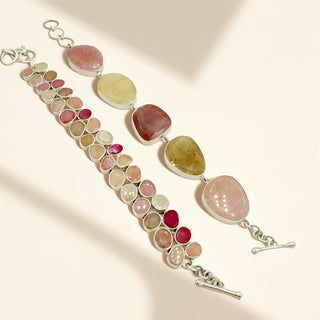 Two bracelets with pink stones on a beige background