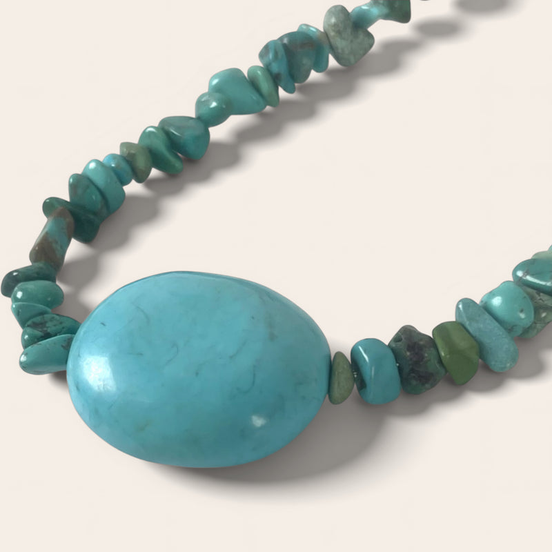 Turquoise beaded necklace on a light background