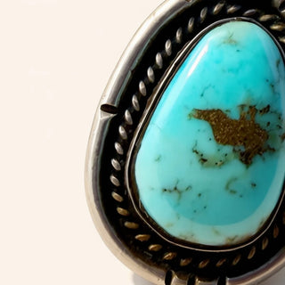 Turquoise ring with silver band on a white background