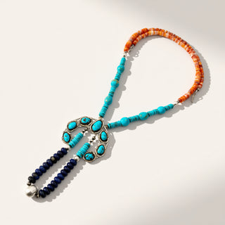 Necklace with turquoise and orange beads on a white background