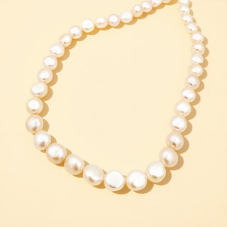 White pearl necklace on a beige background