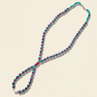 Necklace with multicolored beads on a beige background