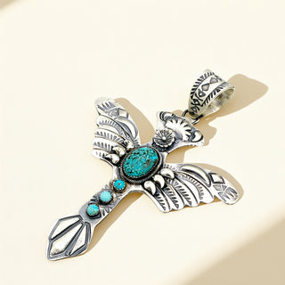 Silver cross pendant with blue stones on a beige background