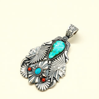 Pendant with Chiefs and turquoise stones on a beige background