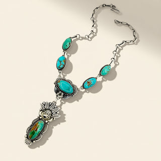 Silver necklace with turquoise stones on a beige background